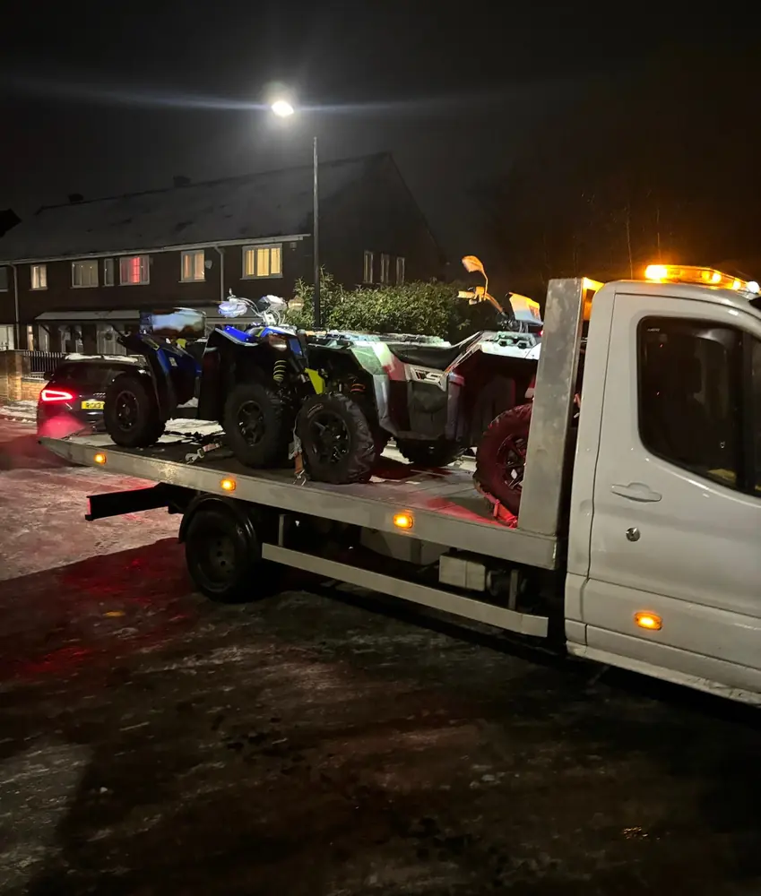 Quad bikes loaded onto the Big Jim's Recovery flatbed for transport