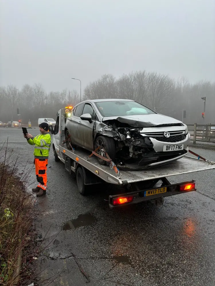 Big Jim's Recovery flatbed collecting a car on a wet road